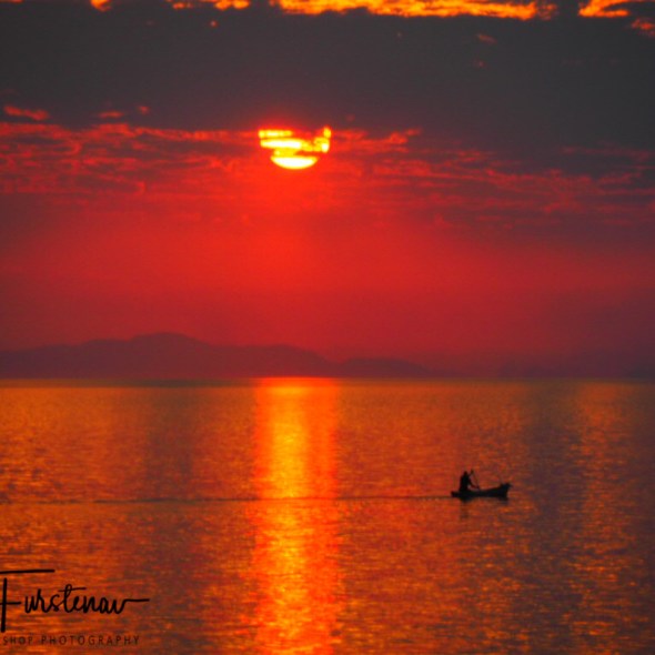 Banana boat fisherman over endless seas at Otter Point, Cape MaClear, Lake Malawi, Malawi