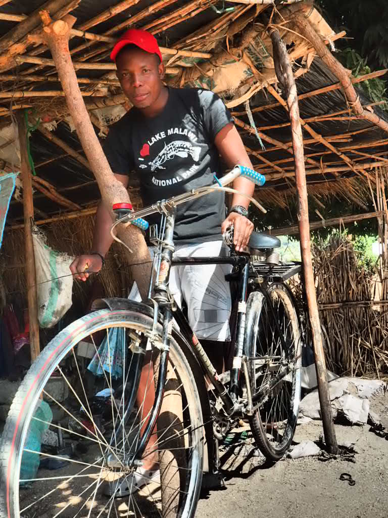 Bike repairs in Chembe, Cape Maclear, Lake Malawi, Malawi 