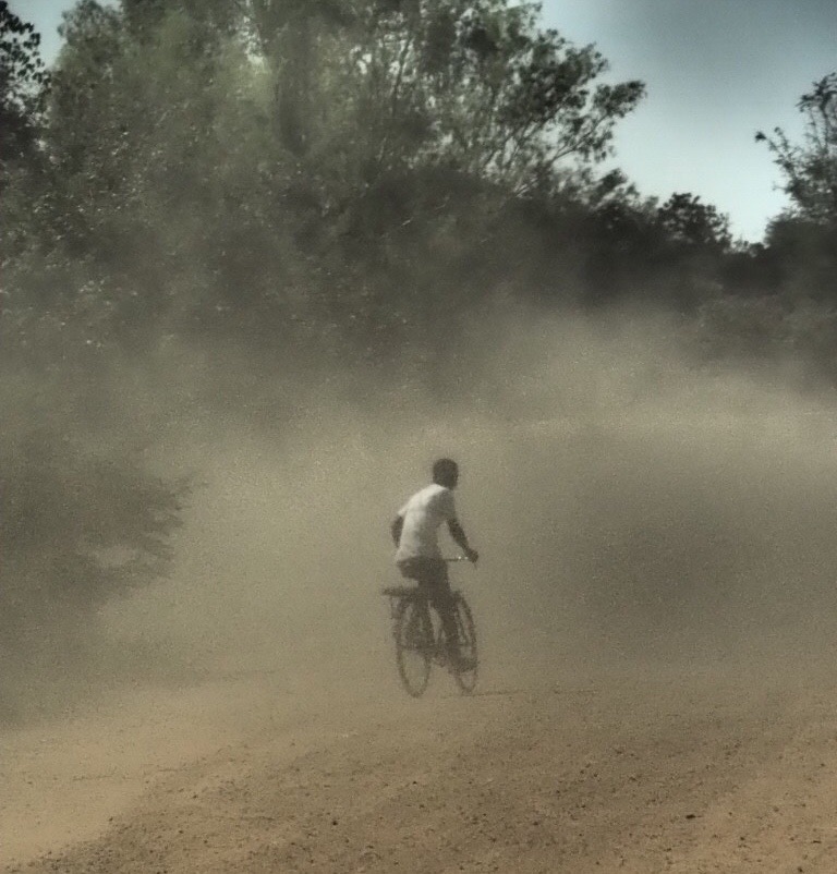 Riding in to the dust around Cape Maclear, Malawi