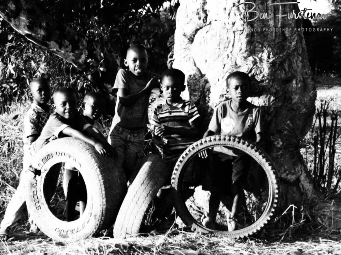 Kids playing with tyres in a remote village in the Northern Region, Malawi