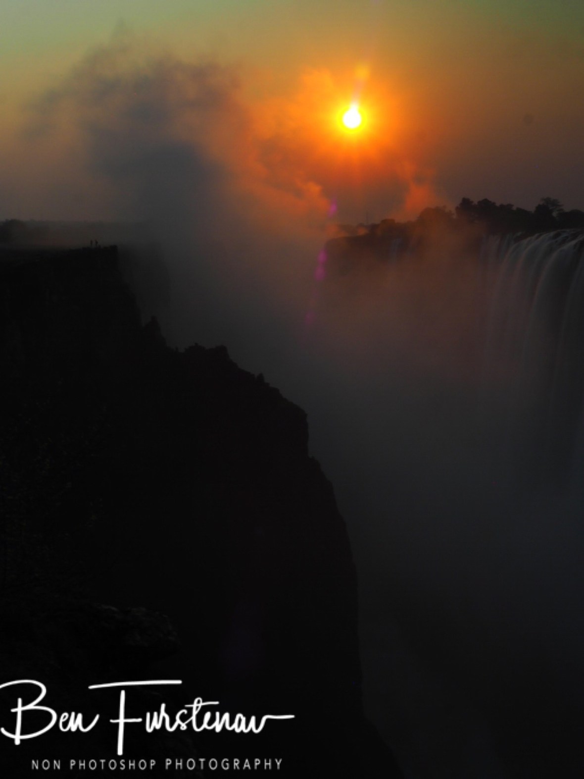 Steaming mist rising up the sun, Victoria Falls, Zambia 