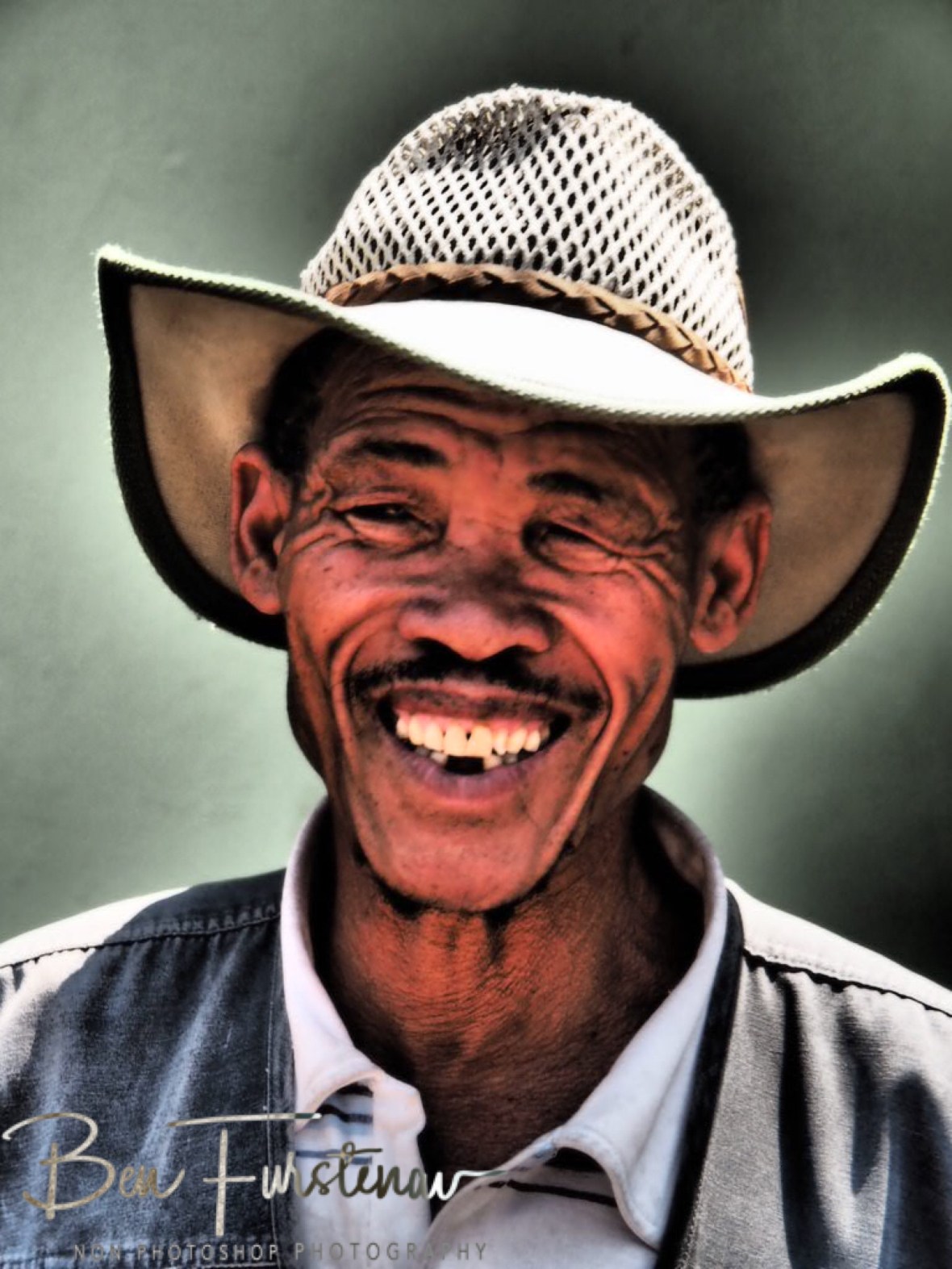 Happy bushman with oversized pants, Tsolido Hills, Kalahari desert, Botswana