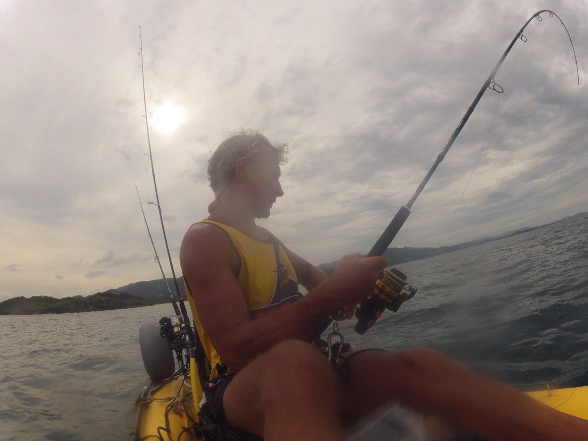 Handling a decent fish on the kayak is not easy, Coffs Harbour coastline, New South Wales, Australia 