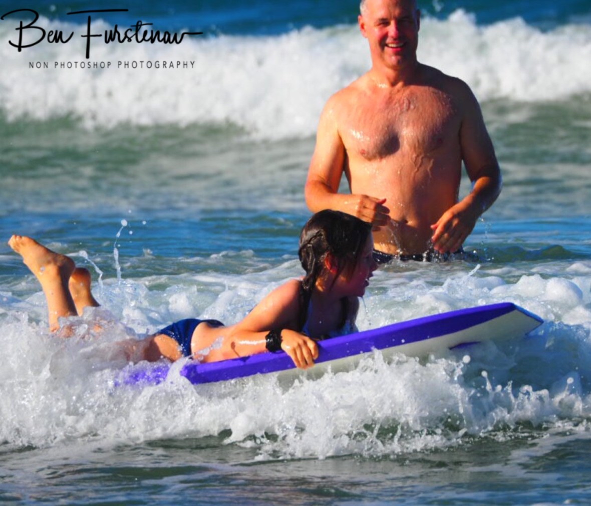 Family fun in the surf at Diggers Beach, New South Wales, Australia