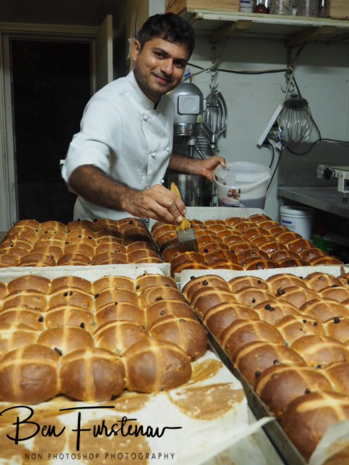 Shailesh glazing hot cross buns, Newrybar, New South Wales, Australia