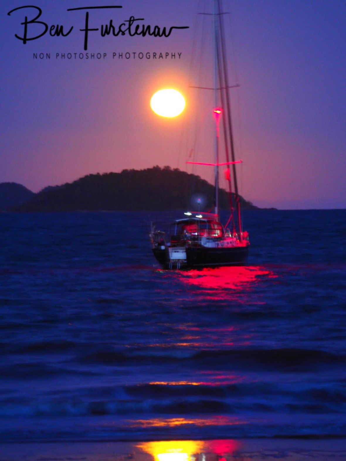 Full moon over anchored yacht at South Mission Beach, Queensland, Australia 
