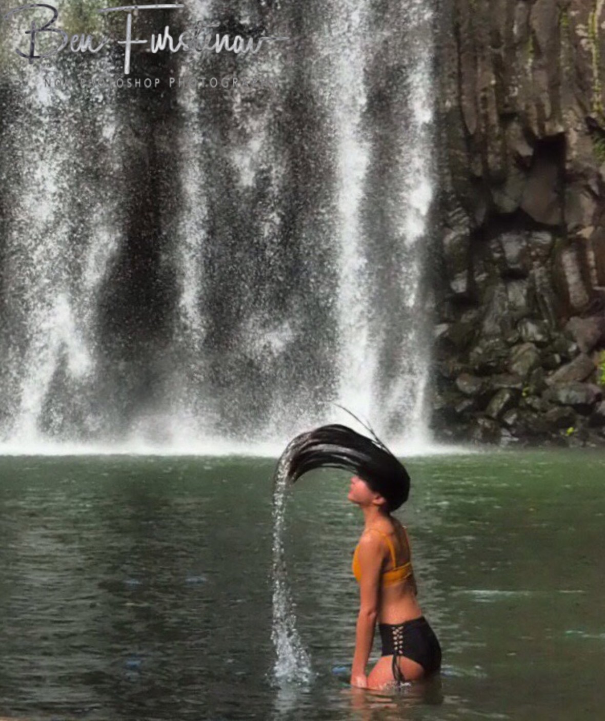 Lifting hair out of water at Millaa Millaa Falls, Atherton Tablelands, Far North Queensland, Australia