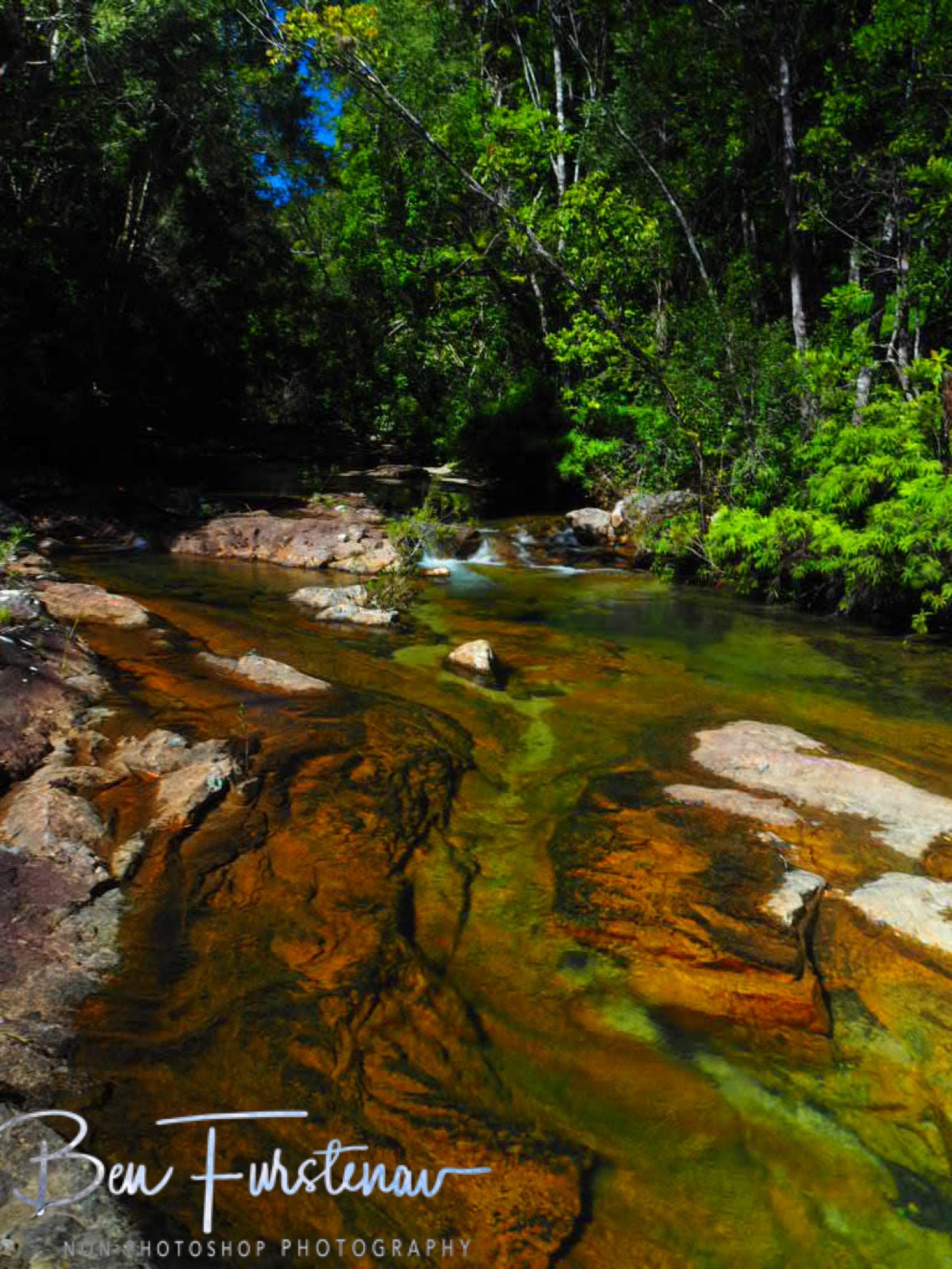 Granite boulders in and above water at Birthday Creek Falls, Northern Queensland, Australia 